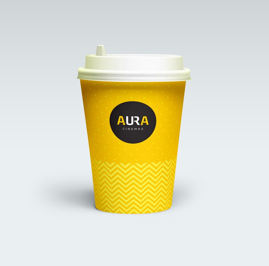 Aura Cinemas branded yellow beverage cup with zigzag pattern and white lid, ideal for a refreshing cinema experience