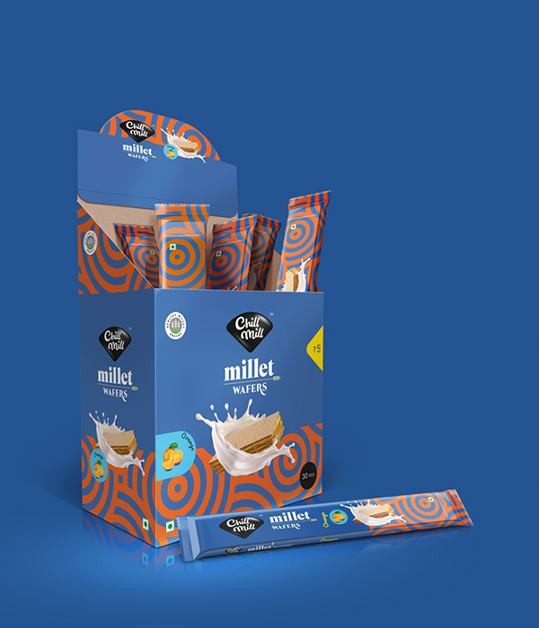 A box of Chillmill Millet Wafers in Orange flavor, with a single wrapped wafer bar lying in front of the box.