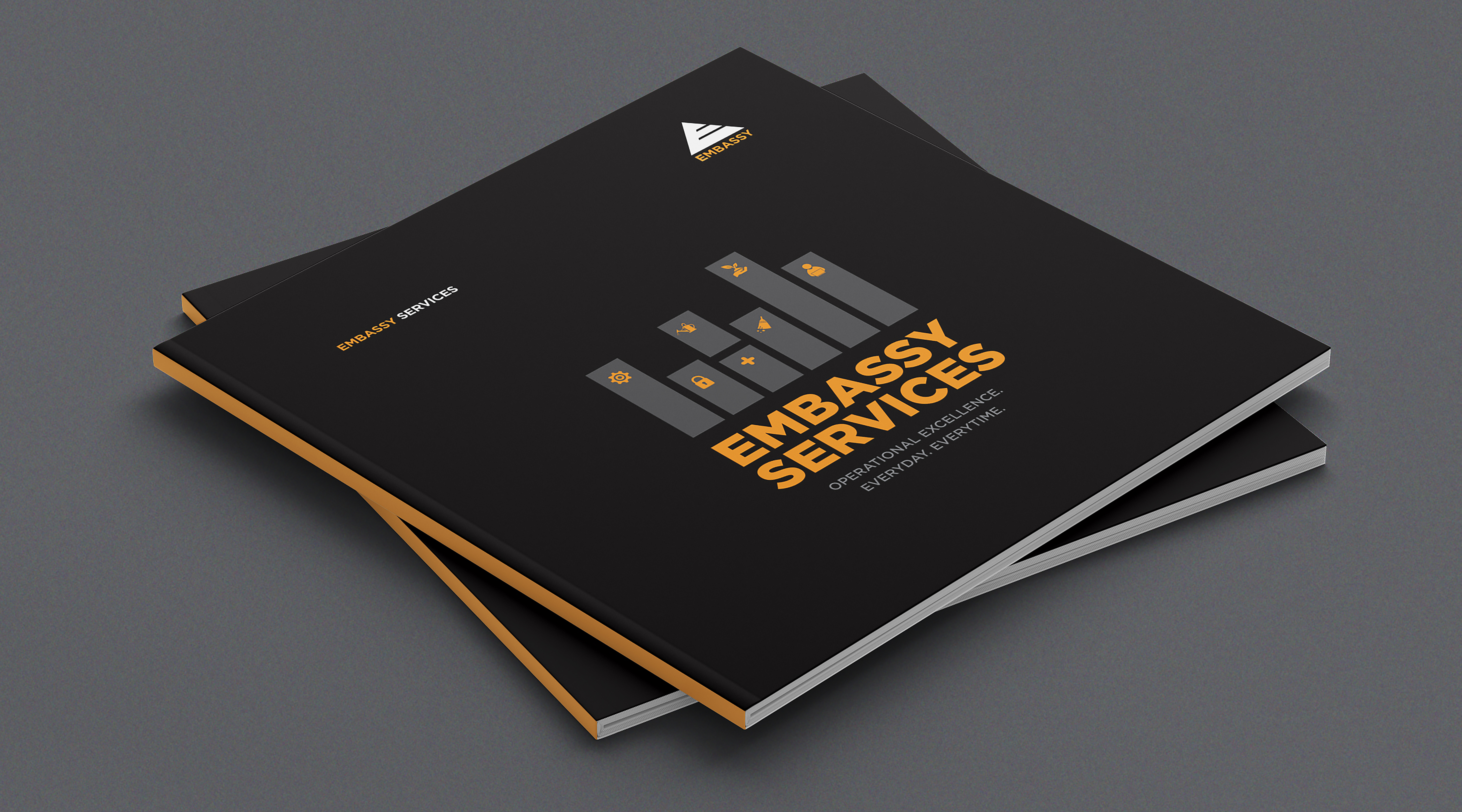 Embassy Services brochure featuring operational excellence theme with icons on black cover design