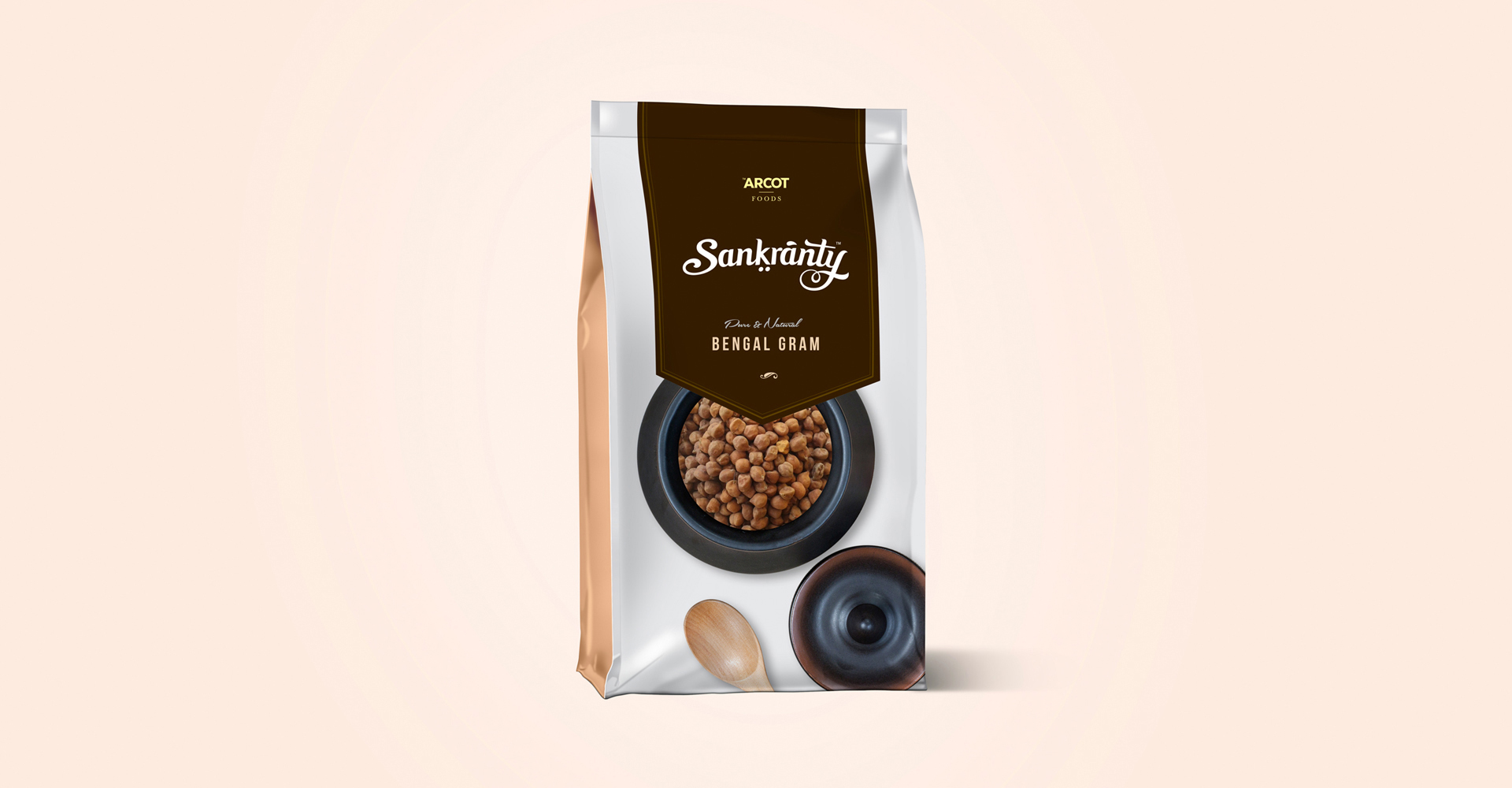 A branded food packaging pouch for Sankranty Bengal Gram, featuring the brand's logo and product name. The packaging has a window showcasing the brown, whole pulses inside, along with an illustration of a single pulse and a pestle and mortar.