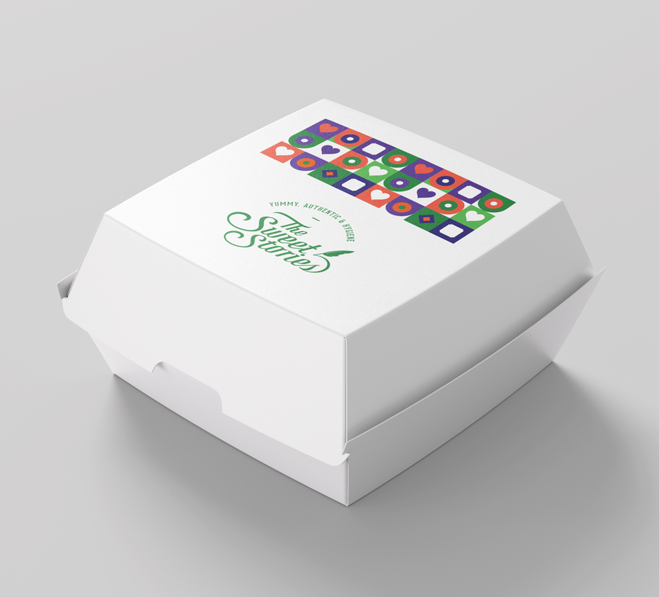 White takeaway box with The Sweet Stories branding and colorful pattern on top – hygienic, authentic, and eco-friendly packaging for Indian sweets and snacks