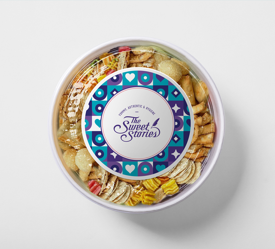 Round snack box with transparent lid showing assorted Indian savory treats, branded with The Sweet Stories logo – hygienic, authentic, and tasty traditional snacks packaging