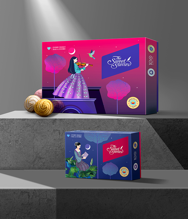 Two elegantly designed Diwali 
                gift boxes from 'The Sweet Stories,' featuring illustrations of a woman playing a violin and a woman reading, with festive elements.