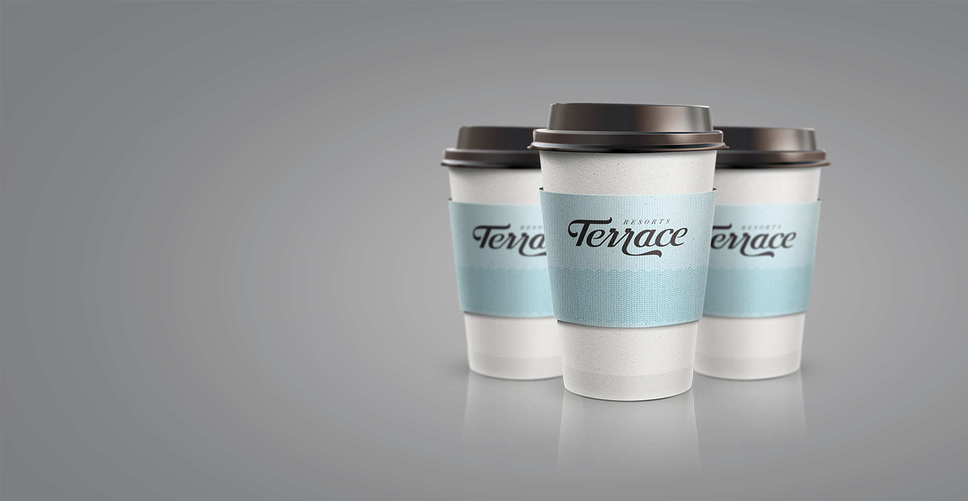 Three white coffee cups with black lids and light blue textured sleeves featuring the cursive Terrace Resorts logo in black. The cups are arranged in a row against a gradient gray background, suggesting a coffee service or branding for the resort.