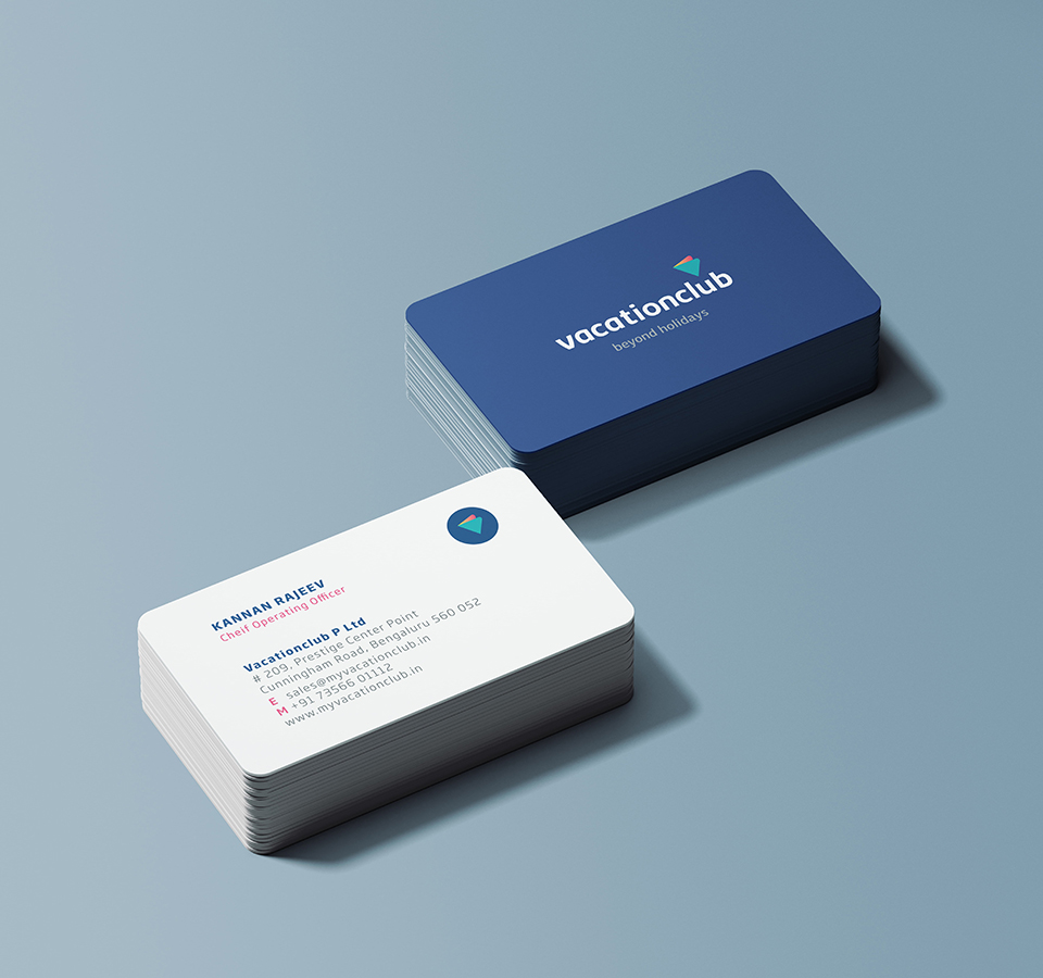 Vacationclub business cards: Stack of blue cards with logo and stack of white cards with contact details for Kannan Rajeev, Chief Operating Officer.