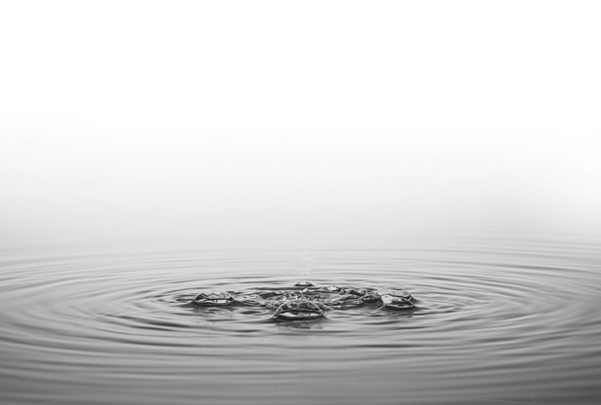 Close-up of Vistara water surface with gentle ripples and bubbles symbolizing tranquility, purity, and natural serenity