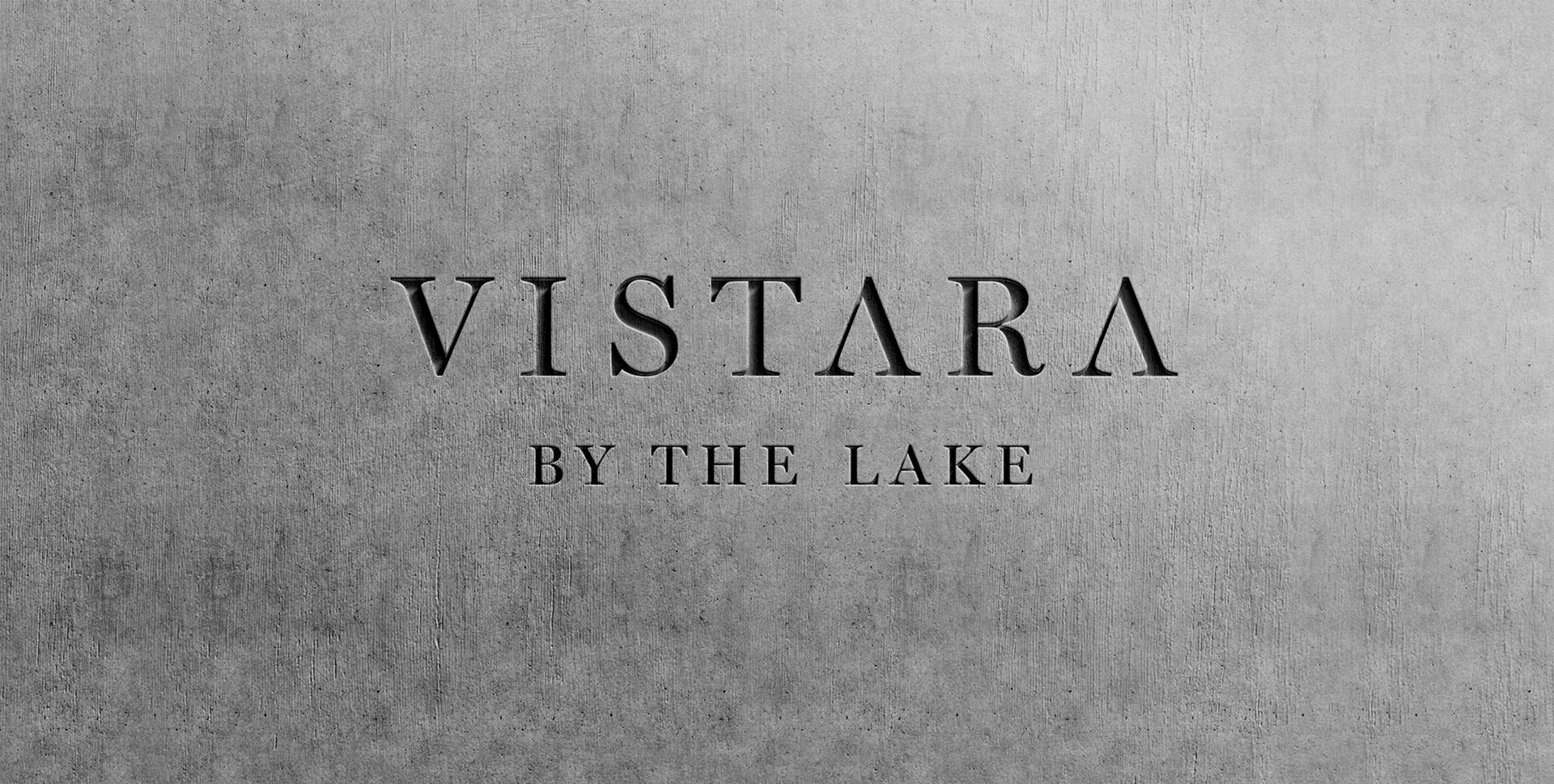 Elegant Vistara by the Lake logo displayed on textured gray surface representing refined resort branding and upscale identity